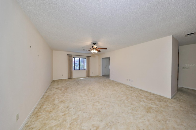 carpeted empty room with a textured ceiling and ceiling fan