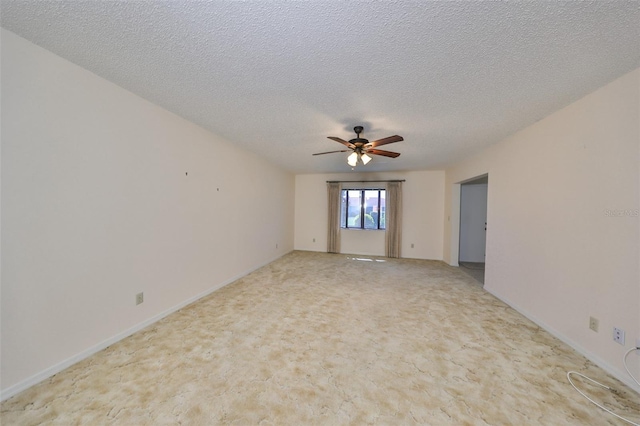 carpeted empty room with a textured ceiling and ceiling fan