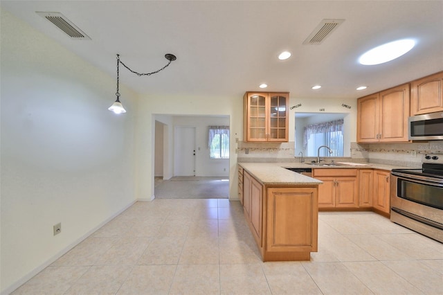 kitchen with light brown cabinetry, kitchen peninsula, stainless steel appliances, decorative light fixtures, and light tile patterned floors