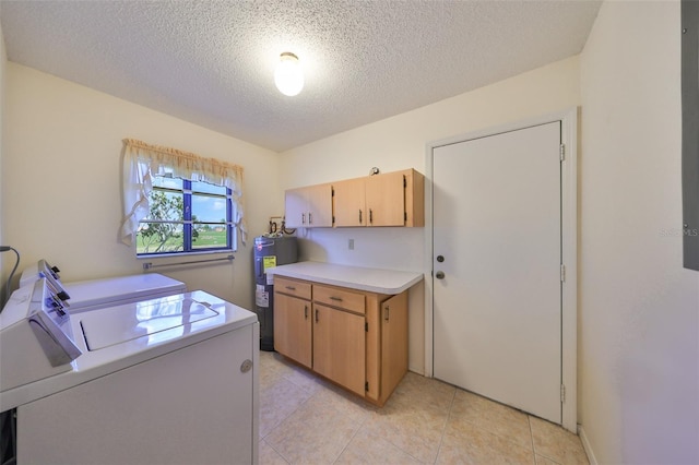 laundry area featuring separate washer and dryer, a textured ceiling, cabinets, electric water heater, and light tile patterned floors