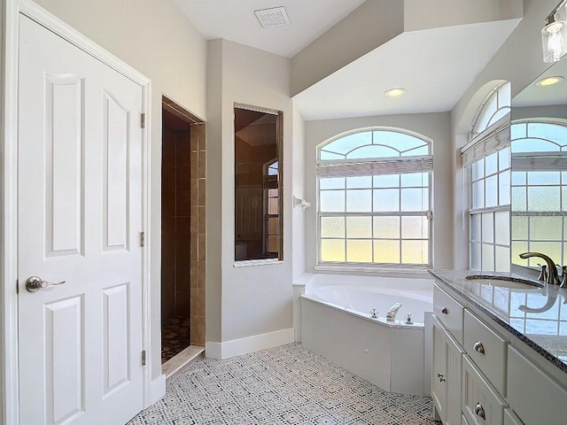 bathroom featuring vanity, independent shower and bath, and tile patterned flooring