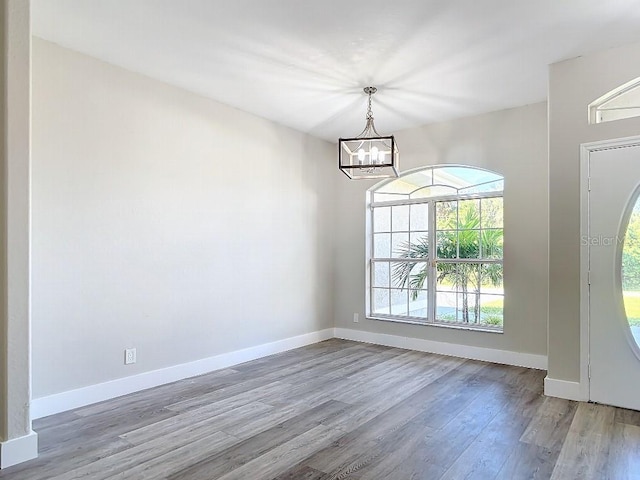 foyer entrance featuring a notable chandelier and light wood-type flooring