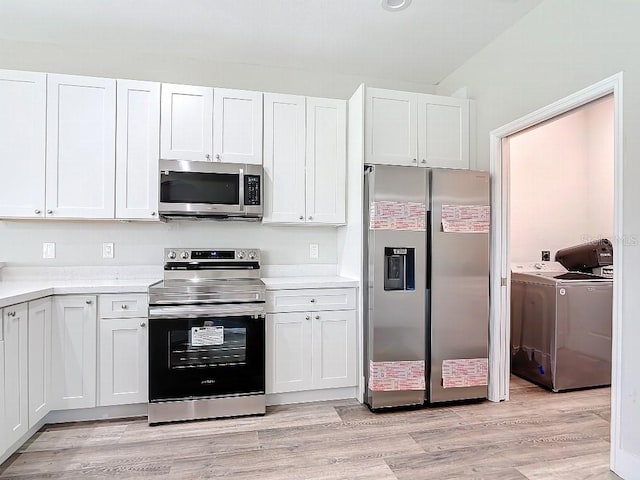 kitchen featuring white cabinetry, light hardwood / wood-style floors, stainless steel appliances, and separate washer and dryer