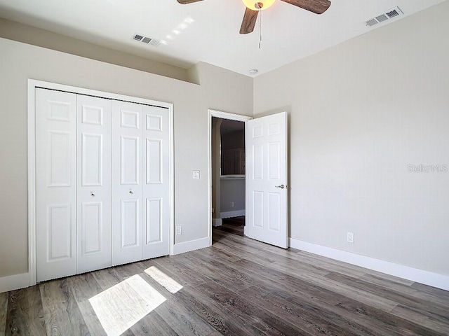 unfurnished bedroom with a closet, ceiling fan, and hardwood / wood-style floors