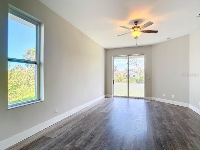 unfurnished room with dark wood-type flooring and ceiling fan