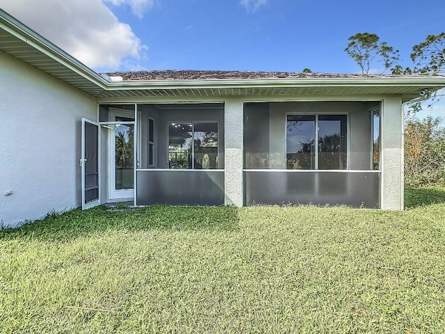 view of property exterior with a yard and a sunroom