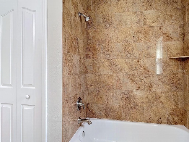 interior details featuring tiled shower / bath combo