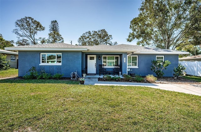 single story home with covered porch and a front lawn