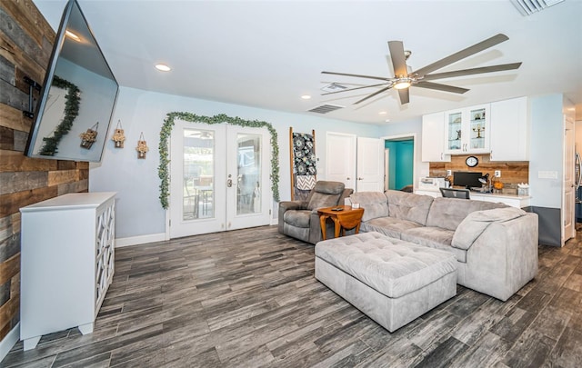 living room featuring french doors, ceiling fan, built in desk, and dark hardwood / wood-style flooring