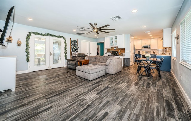 living room featuring french doors, ceiling fan, and dark hardwood / wood-style floors