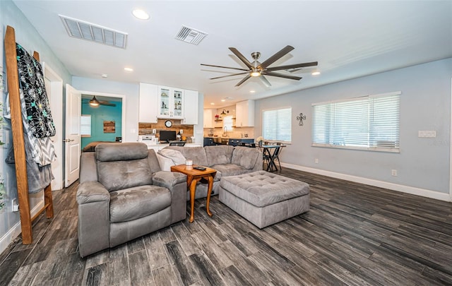 living room featuring dark hardwood / wood-style floors and ceiling fan