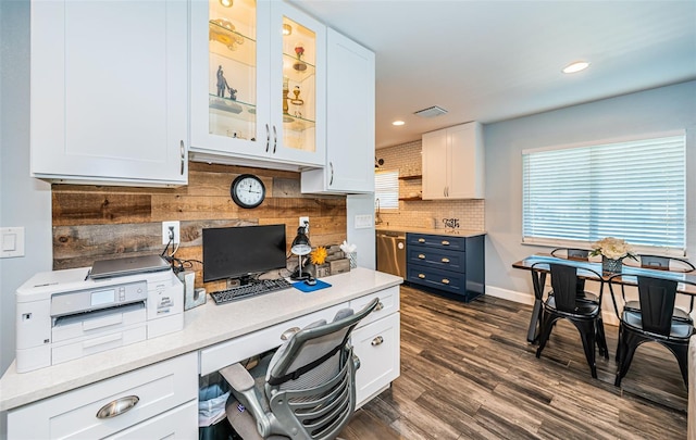 office space featuring built in desk and dark hardwood / wood-style flooring