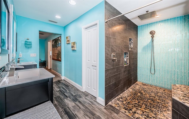 bathroom featuring vanity and a tile shower