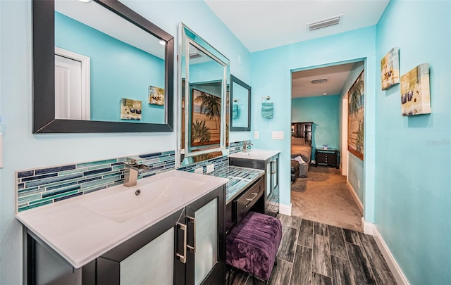 bathroom featuring vanity, hardwood / wood-style flooring, and decorative backsplash