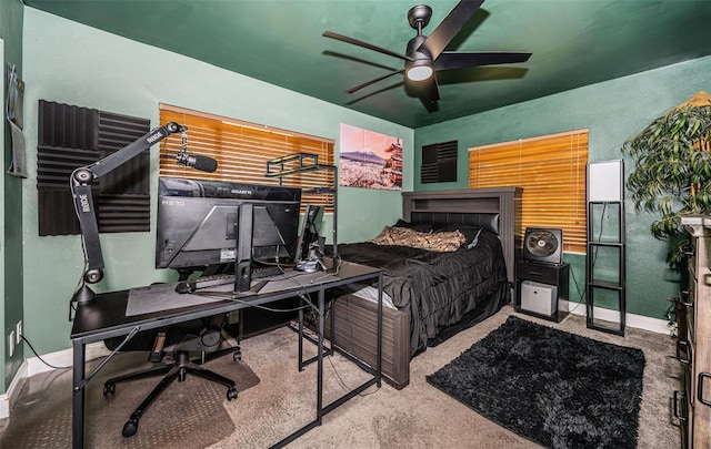 bedroom with light carpet, a fireplace, and ceiling fan