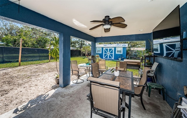 view of patio with a storage unit and ceiling fan