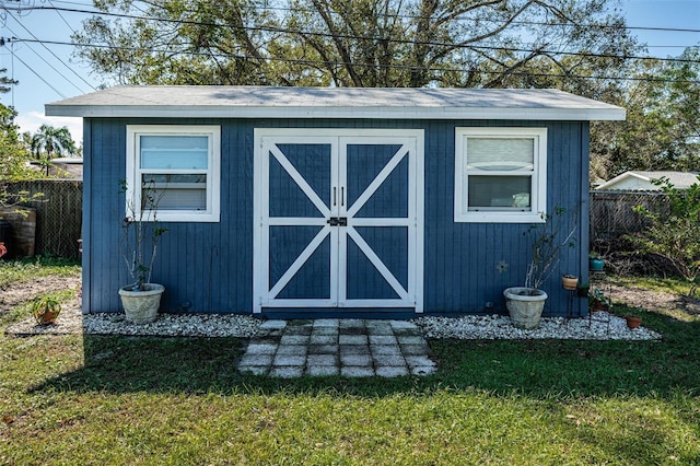 view of outbuilding featuring a yard