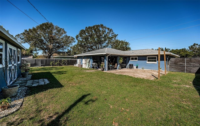 back of house with a lawn