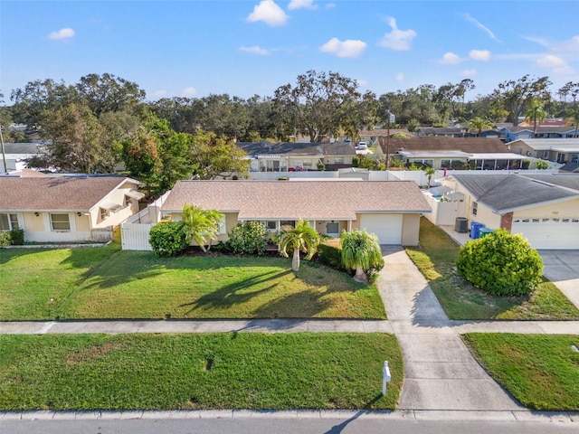 view of front of home featuring a front yard and a garage