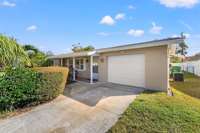 ranch-style home featuring cooling unit, a front lawn, and a garage