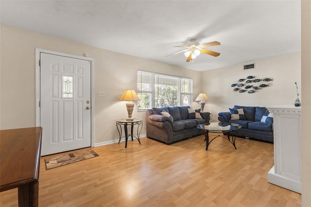 living room featuring light wood-type flooring and ceiling fan