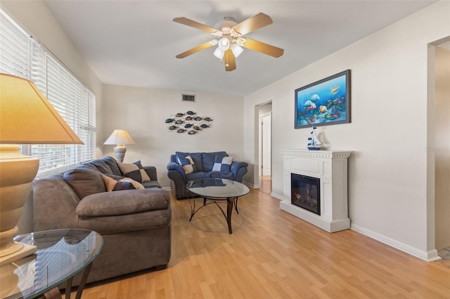 living room featuring light hardwood / wood-style flooring and ceiling fan