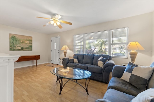 living room featuring light hardwood / wood-style floors and ceiling fan