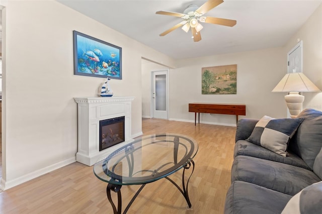 living room featuring light hardwood / wood-style flooring and ceiling fan