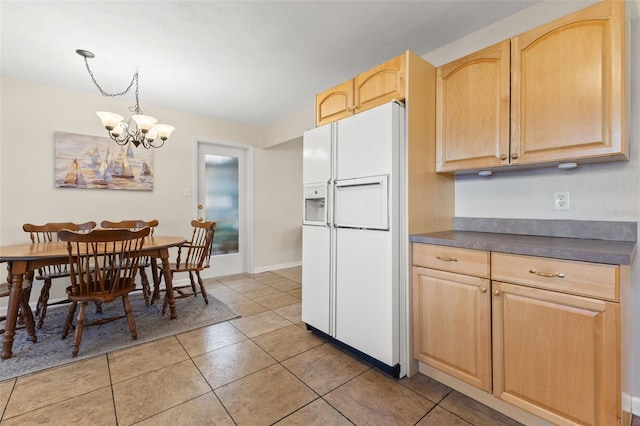 kitchen with light brown cabinets, white refrigerator with ice dispenser, pendant lighting, light tile patterned floors, and a chandelier