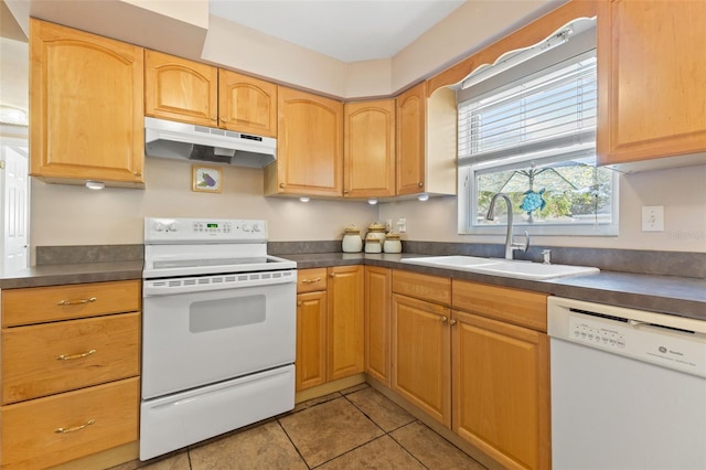 kitchen featuring white appliances, light tile patterned floors, and sink