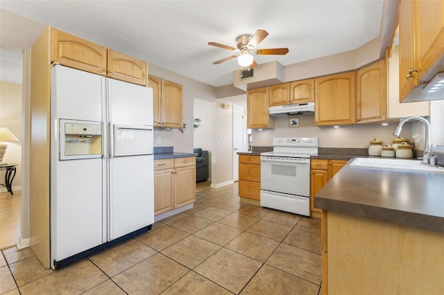 kitchen with light brown cabinetry, sink, and white appliances