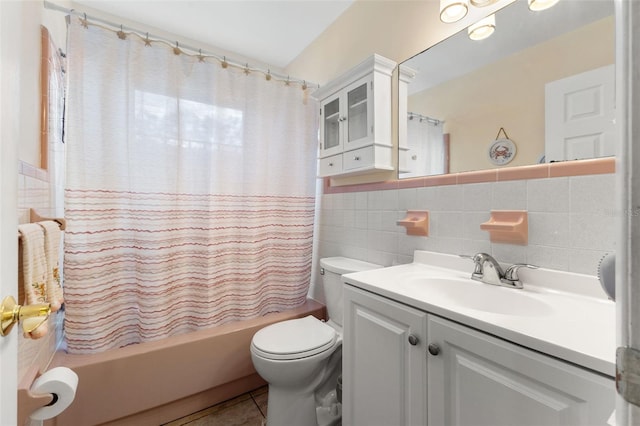 full bathroom featuring shower / bath combo, toilet, tile walls, vanity, and tile patterned flooring