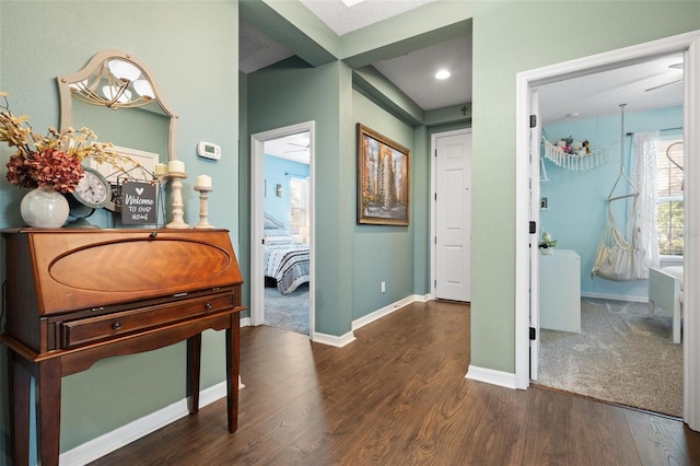 hall with dark hardwood / wood-style flooring