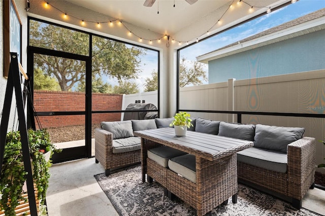 sunroom / solarium featuring track lighting and ceiling fan