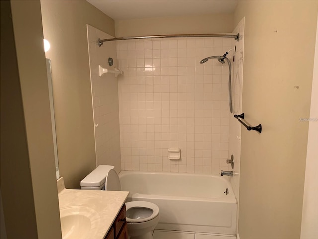 full bathroom featuring toilet, tiled shower / bath, and vanity