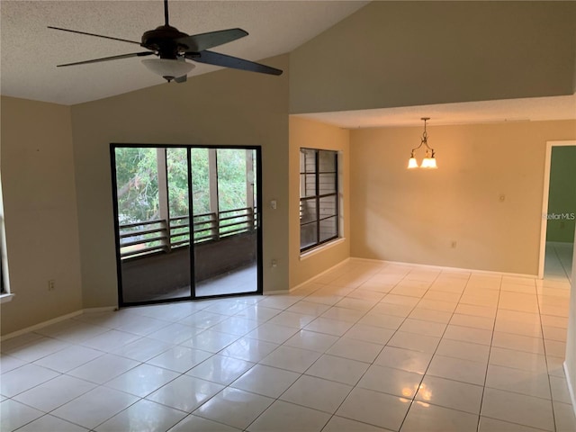 tiled empty room featuring high vaulted ceiling, a textured ceiling, and ceiling fan with notable chandelier