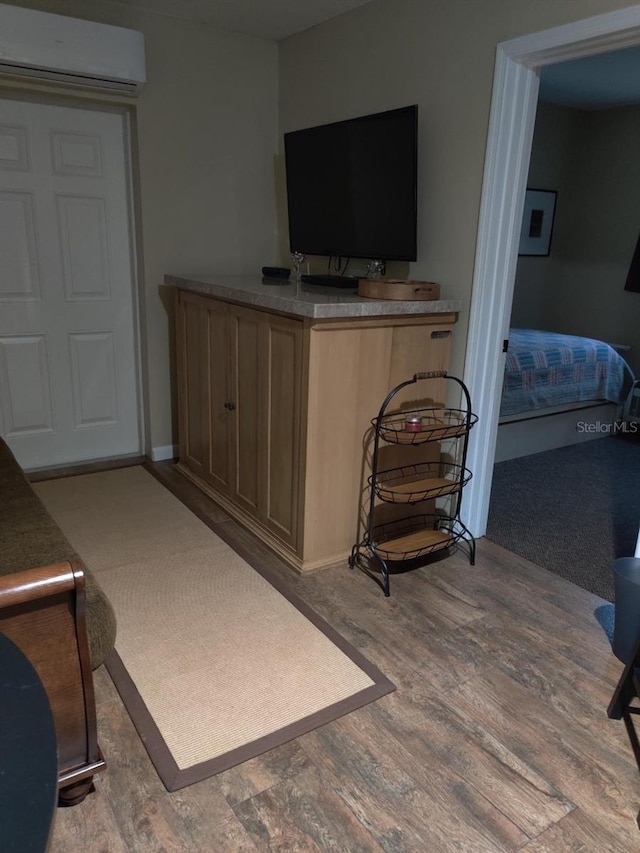 interior space featuring a wall mounted AC and light hardwood / wood-style flooring