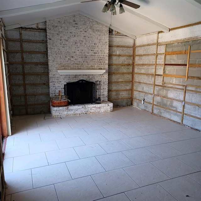 unfurnished living room featuring vaulted ceiling with beams, light tile patterned floors, a fireplace, and ceiling fan