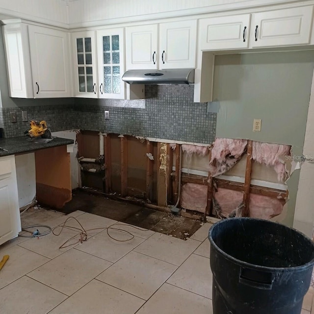 kitchen featuring white cabinets, tasteful backsplash, and light tile patterned floors