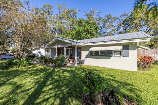 rear view of property with a porch and a lawn