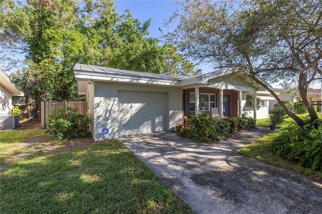 view of front of property with a garage, a front lawn, a porch, and central air condition unit