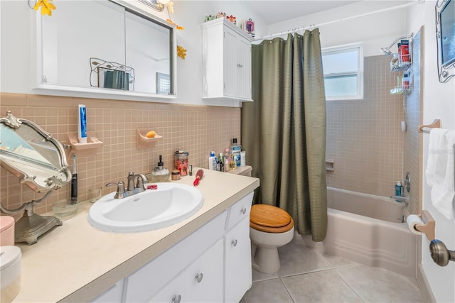 full bathroom with tile patterned flooring, vanity, shower / tub combo, tile walls, and toilet