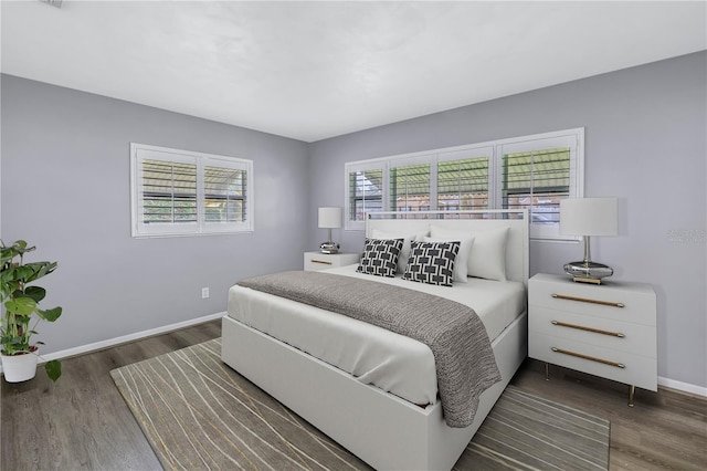 bedroom with dark hardwood / wood-style floors