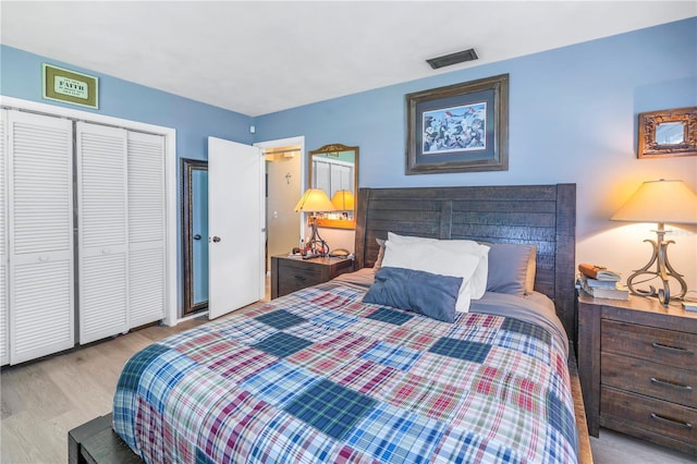 bedroom with light wood-type flooring and a closet