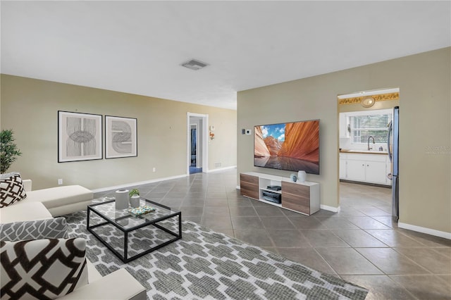 tiled living room featuring sink