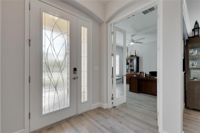 foyer entrance with light hardwood / wood-style floors and ceiling fan