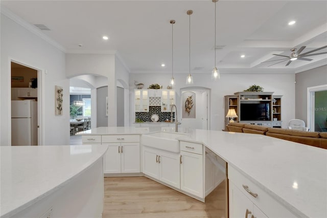 kitchen featuring pendant lighting, sink, white cabinets, white refrigerator, and stainless steel dishwasher