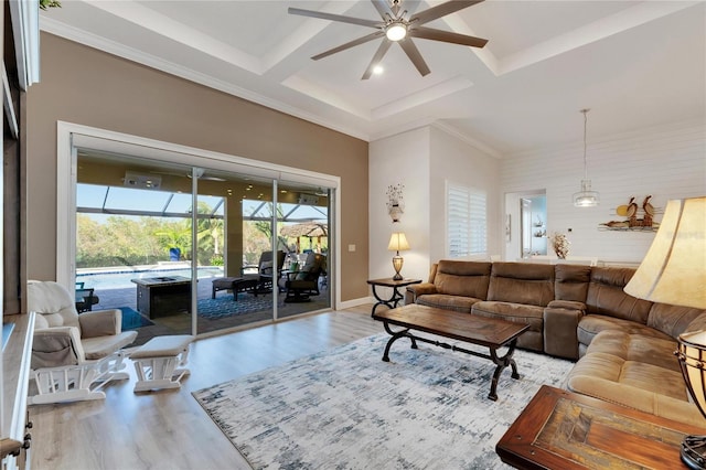 living room with coffered ceiling, light hardwood / wood-style flooring, ornamental molding, beamed ceiling, and ceiling fan