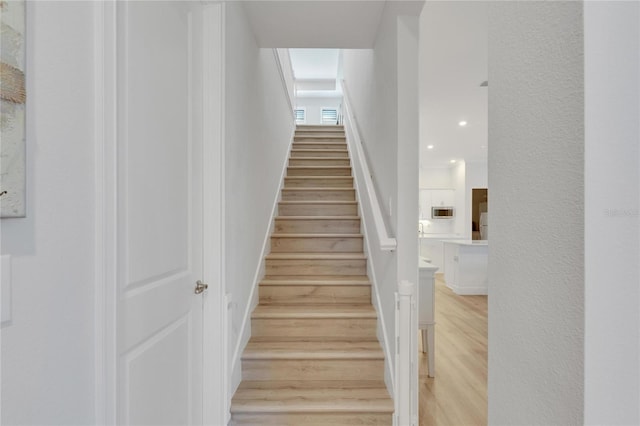 stairway featuring hardwood / wood-style floors