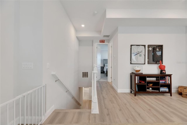 hallway with light hardwood / wood-style flooring